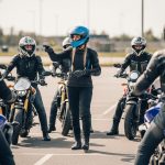 A group of motorcyclists holds a pre-ride talk to review safety essentials before group riding.
